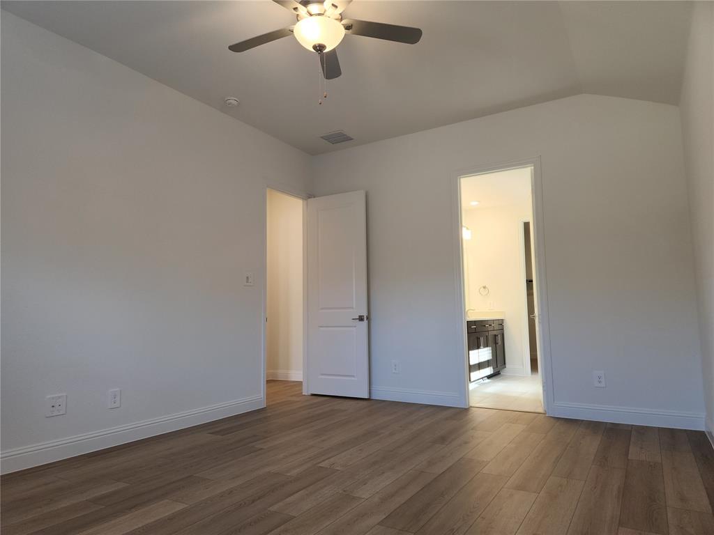 2433 Glacier Ridge Corinth, TX 76210 - Photo 23 of 40 a view of an empty room with wooden floor