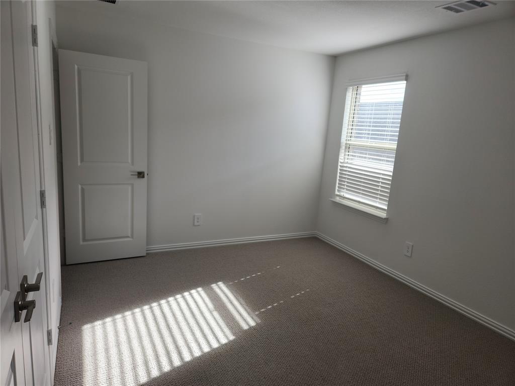 2433 Glacier Ridge Corinth, TX 76210 - Photo 33 of 40 an empty room with windows