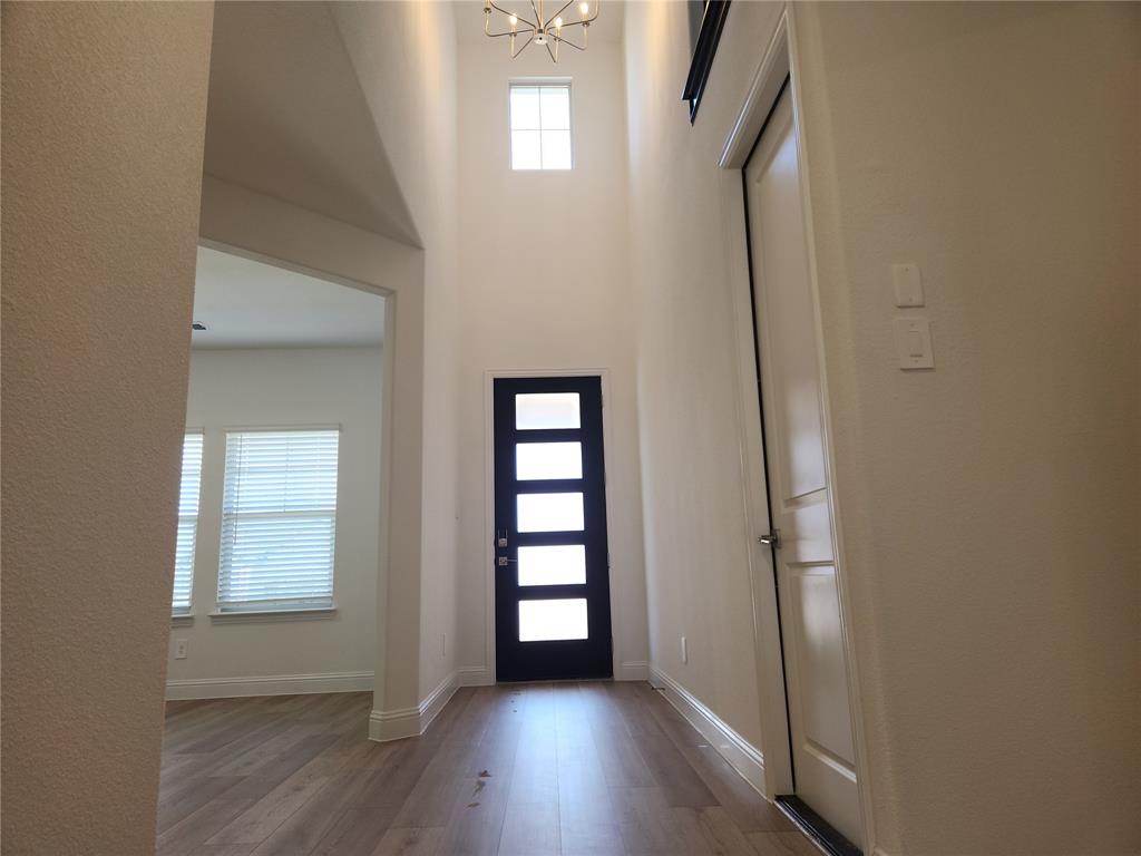 2433 Glacier Ridge Corinth, TX 76210 - Photo 6 of 40 an empty room with wooden floor closet and windows