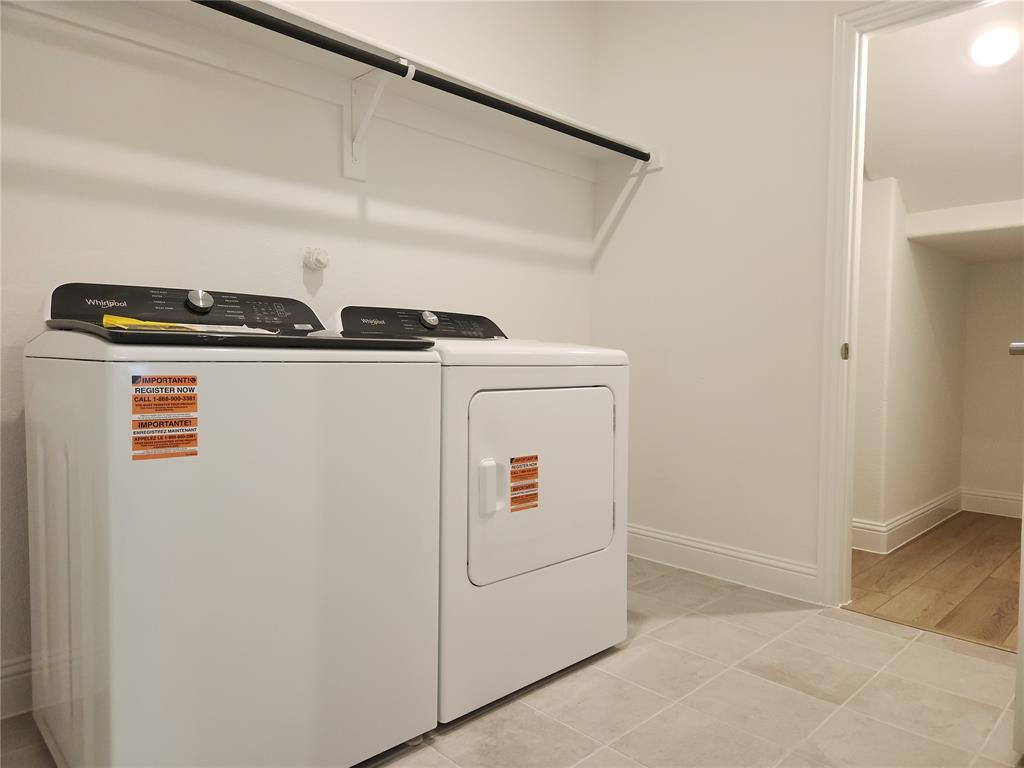 2433 Glacier Ridge Corinth, TX 76210 - Photo 10 of 40 a utility room with dryer and washer