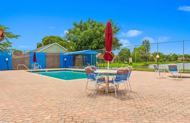 a patio with a table and chairs