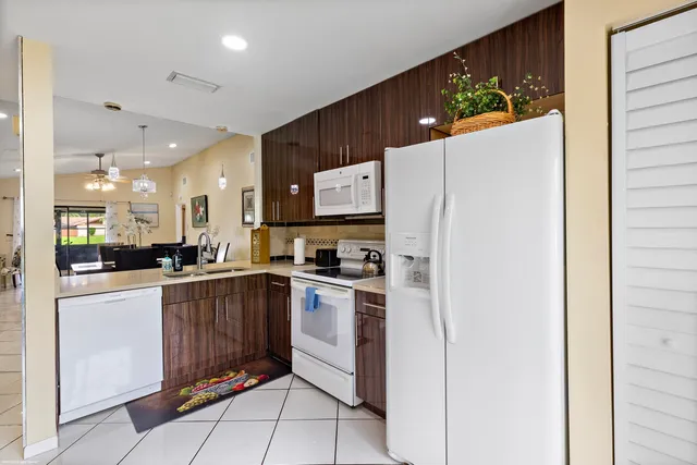 a kitchen with stainless steel appliances granite countertop a refrigerator and a stove top oven