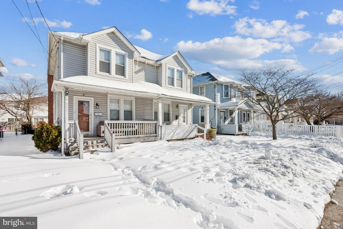 a view of a house with a yard covered in snow