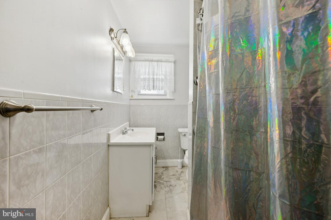 525 Bridgeboro Street Riverside, NJ 08075 - Photo 13 of 16 a bathroom with a sink a mirror and shower