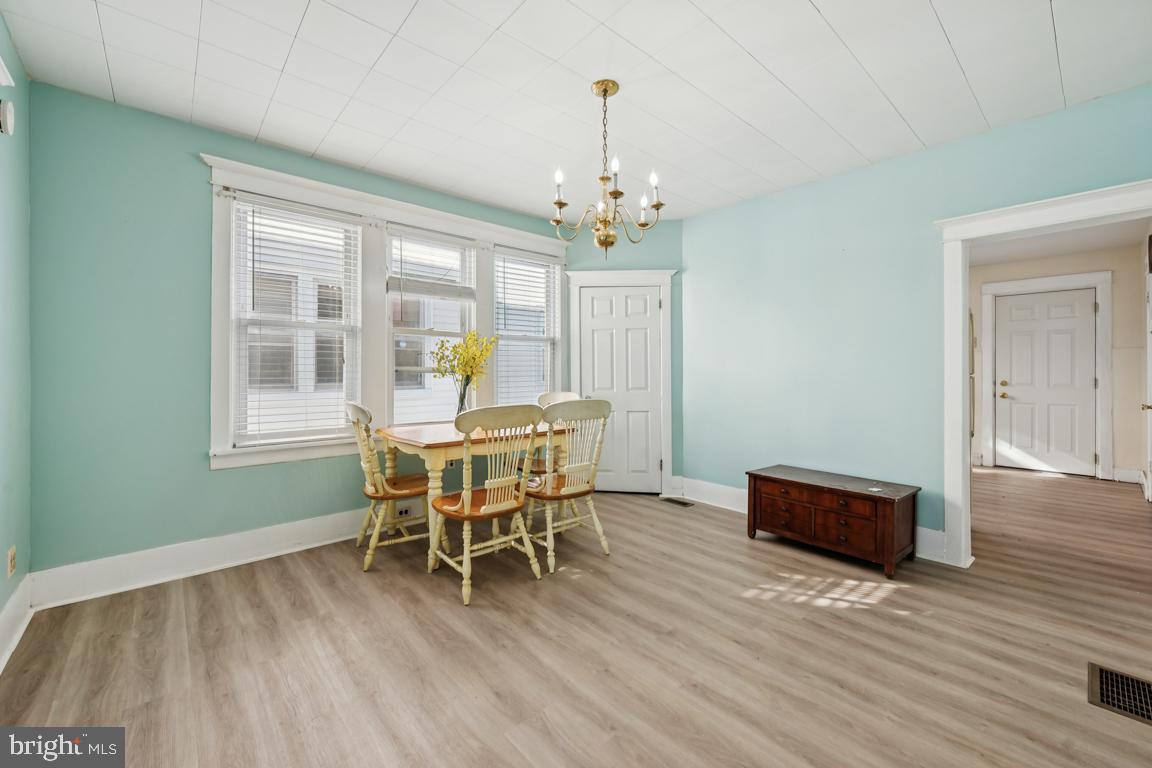 525 Bridgeboro Street Riverside, NJ 08075 - Photo 4 of 16 a dining room with furniture a chandelier and wooden floor