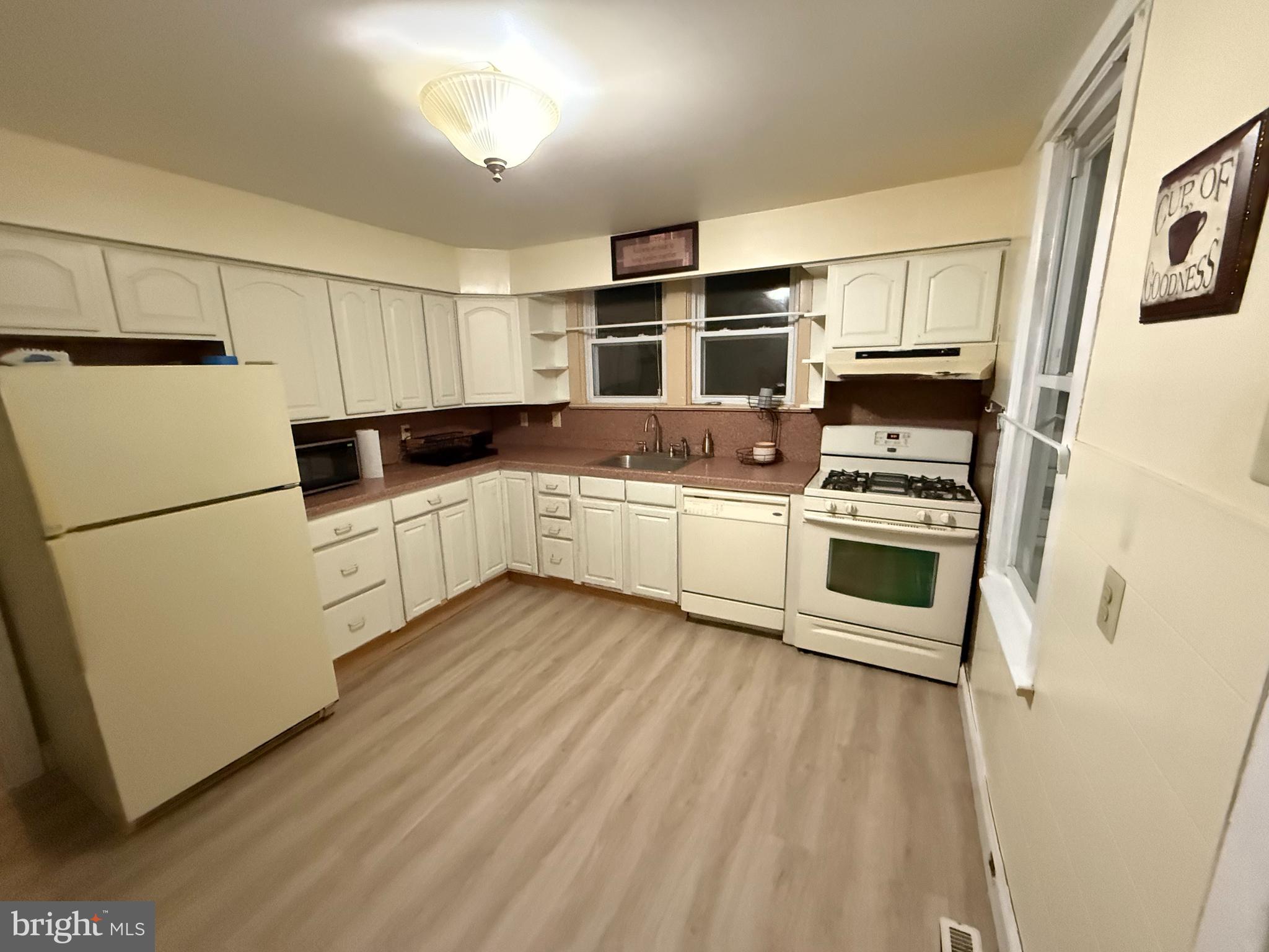 525 Bridgeboro Street Riverside, NJ 08075 - Photo 5 of 16 a kitchen with white cabinets and white appliances