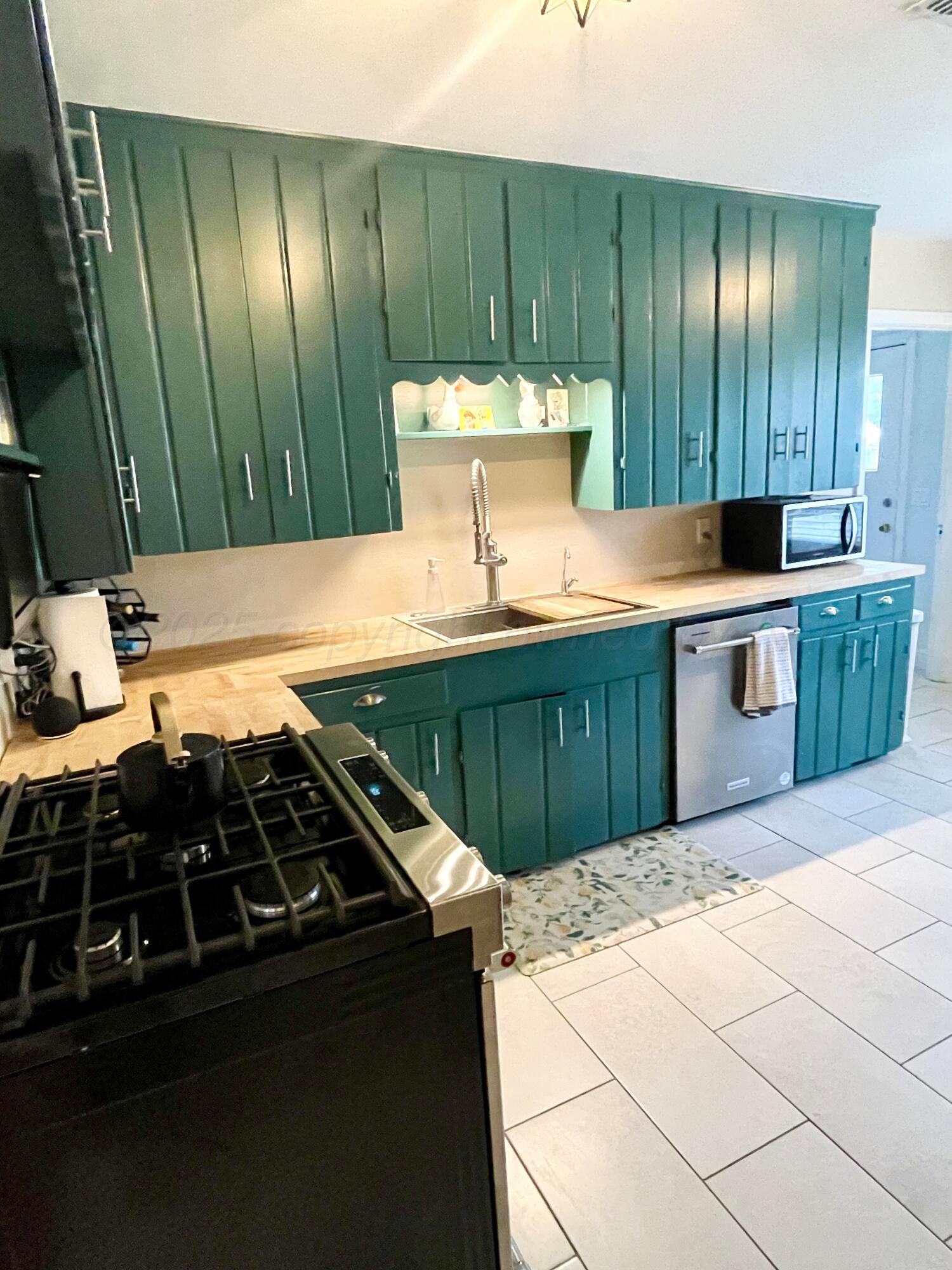 2406 Juniper Drive Amarillo, TX 79109 - Photo 12 of 28 a kitchen with a sink and a stove