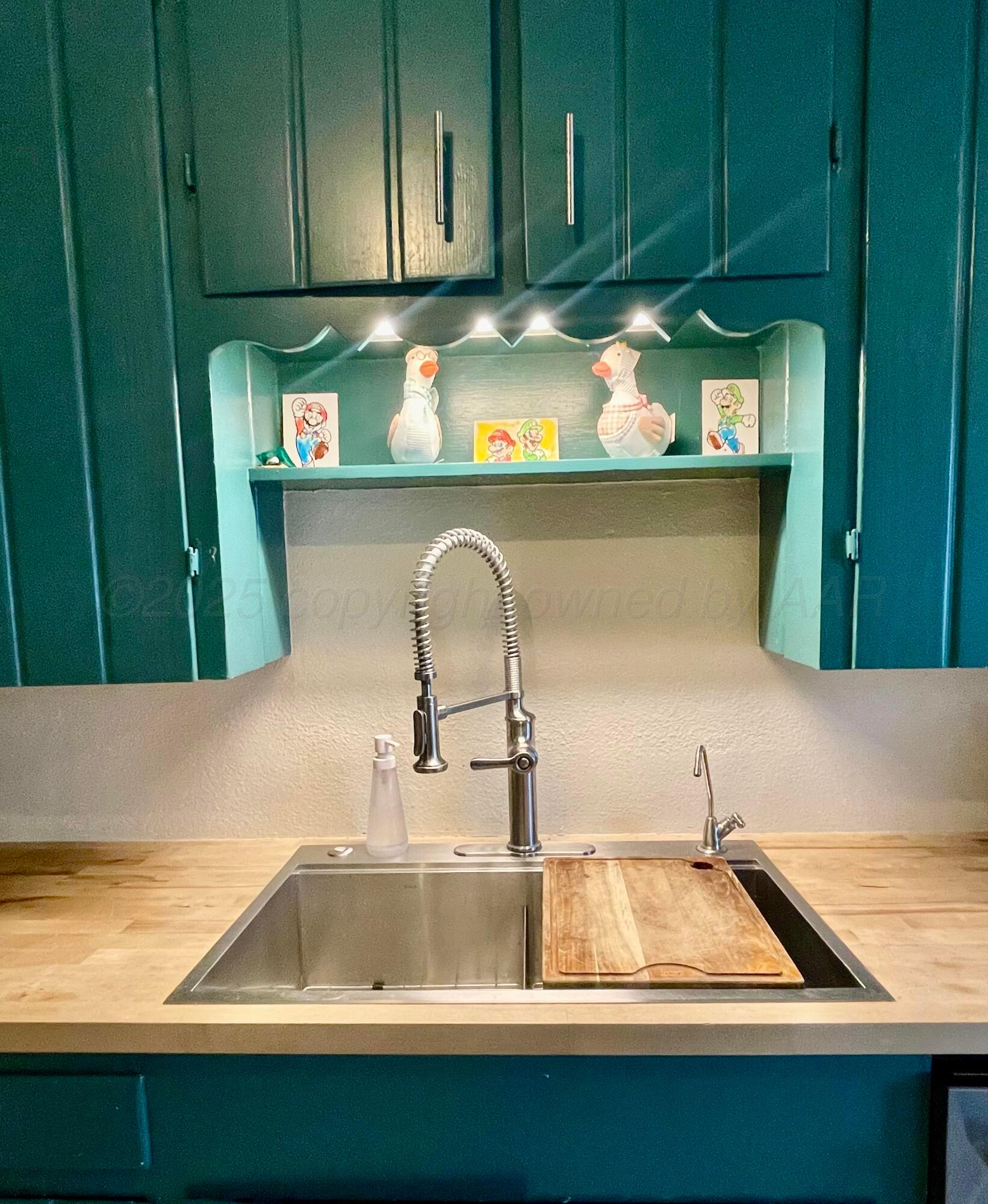 2406 Juniper Drive Amarillo, TX 79109 - Photo 13 of 28 a kitchen with washing machine and cabinets