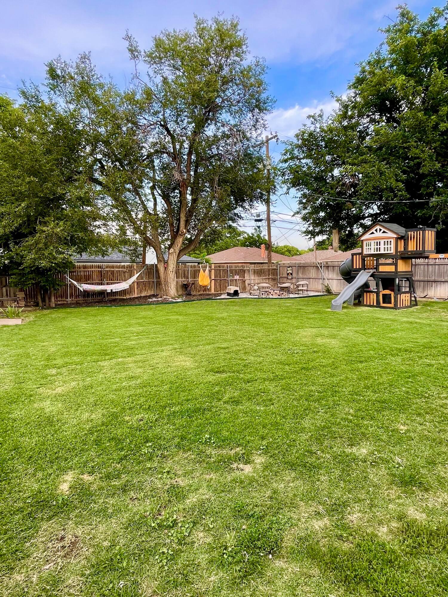 2406 Juniper Drive Amarillo, TX 79109 - Photo 4 of 28 a view of a yard with a house in the background