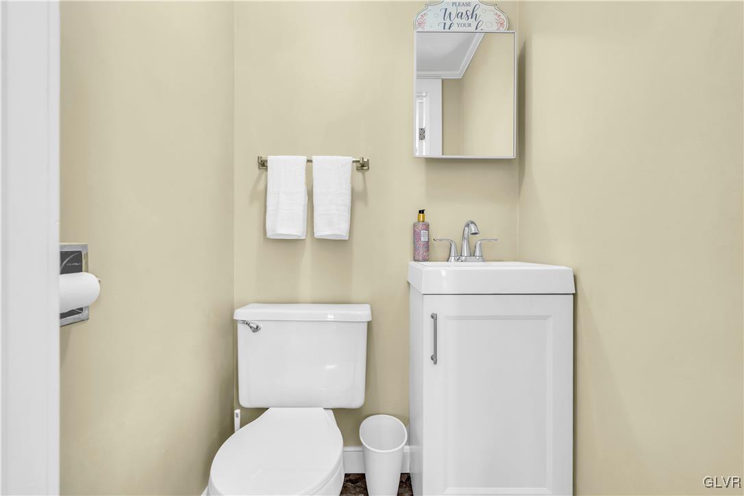 975 State Park Road Wind Gap, PA 18091 - Photo 13 of 17 a bathroom with a toilet sink vanity and mirror