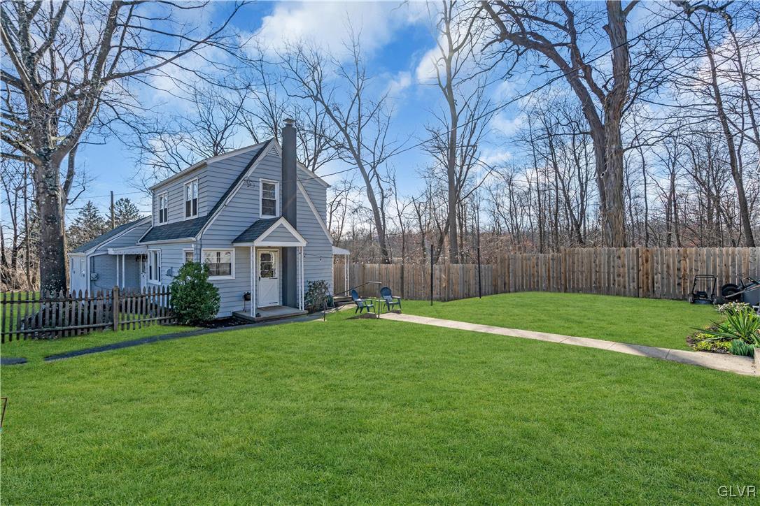 975 State Park Road Wind Gap, PA 18091 - Photo 15 of 17 a house that is sitting in the grass with tress in the background