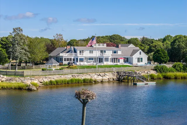 a front view of a dining room with furniture wooden floor and windows