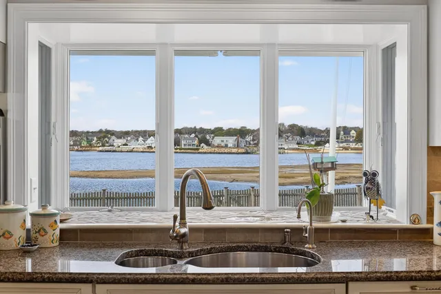 a bathroom with a granite countertop sink a toilet and a mirror