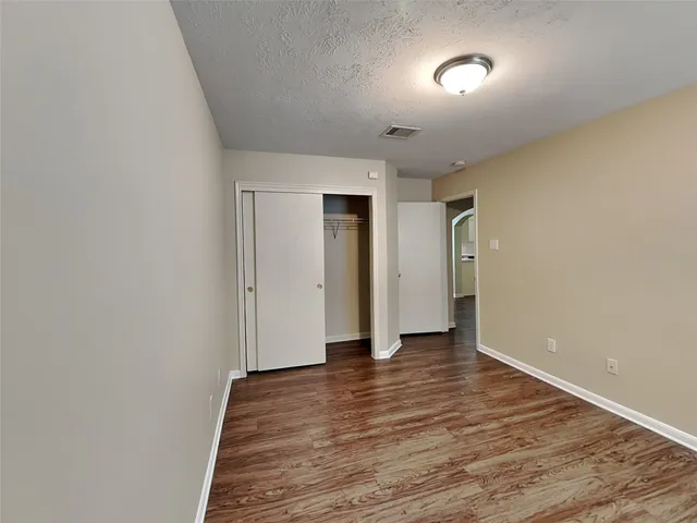 a view of an empty room and wooden floor