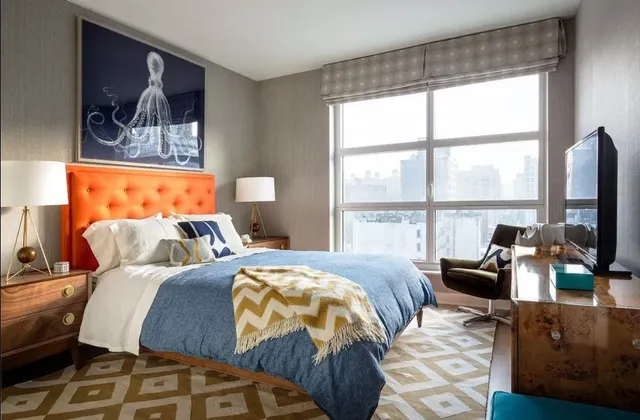 a bedroom with two beds and a large window