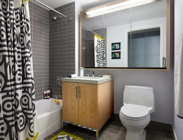 a bathroom with a sink toilet and shower