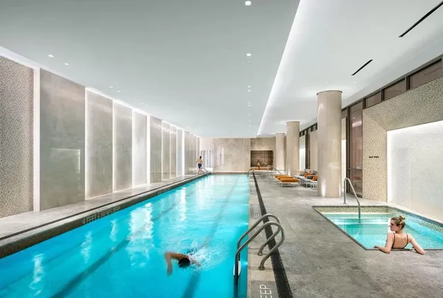 a room with lots of potted plants and wooden floors