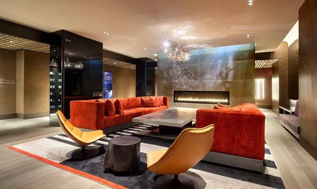 a living room with furniture pool and a fireplace