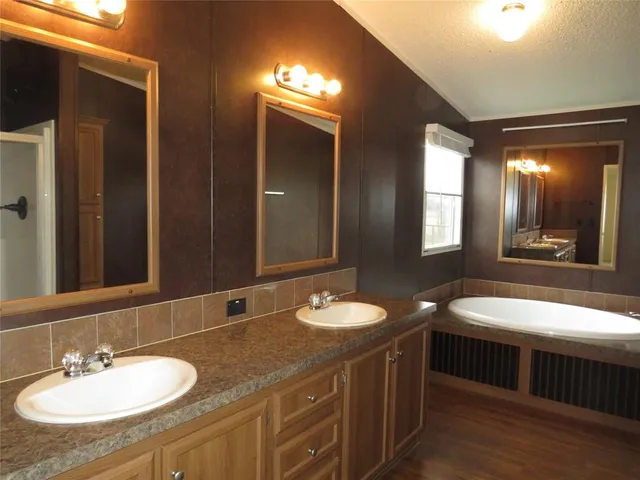 a bathroom with a double vanity sink and a mirror