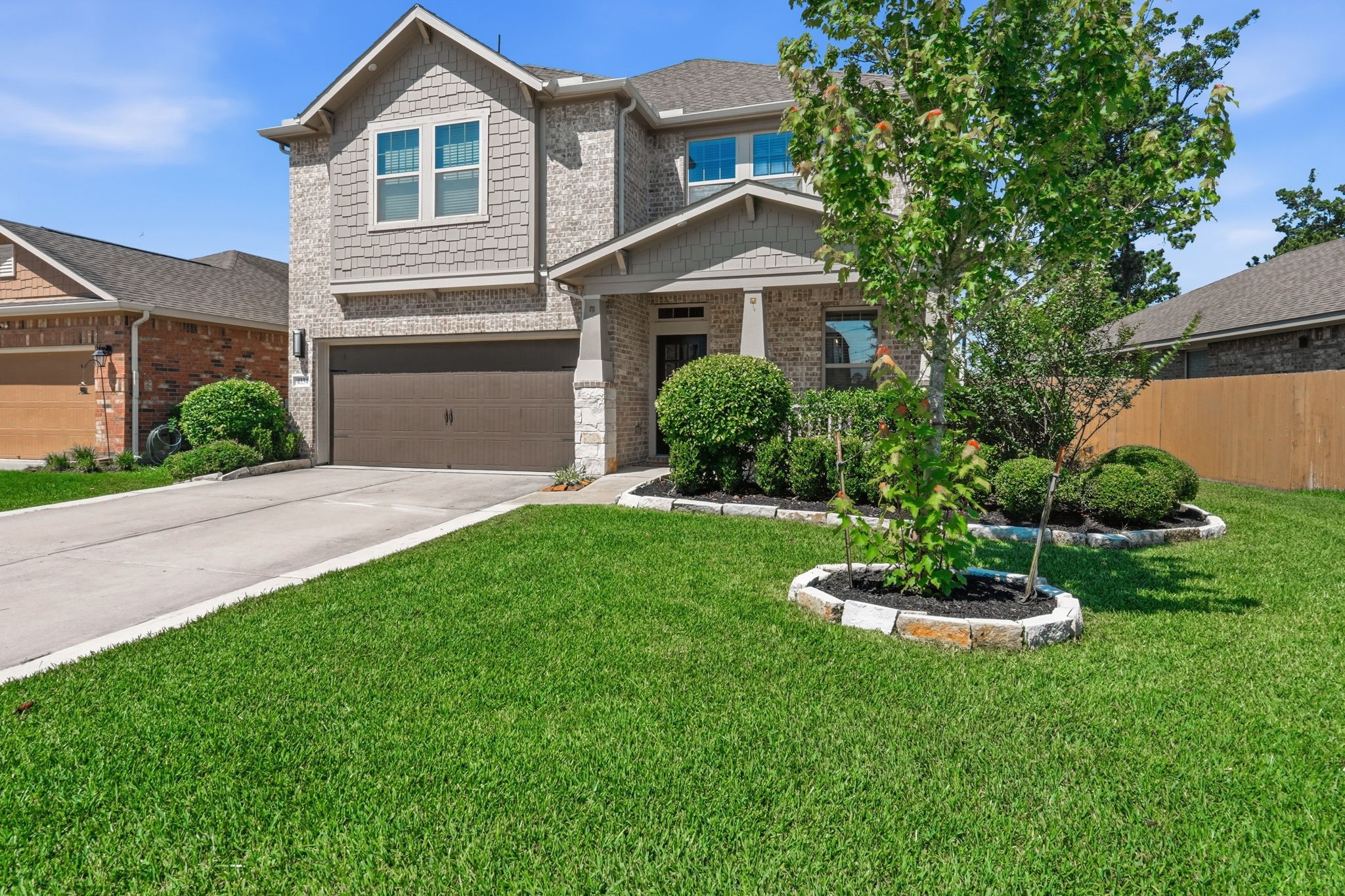 4334 Umber Shadow Drive Spring, TX 77386 - Photo 39 of 45 Alternate exterior view highlights the manicured front lawn, mature landscaping, and inviting covered front porch.