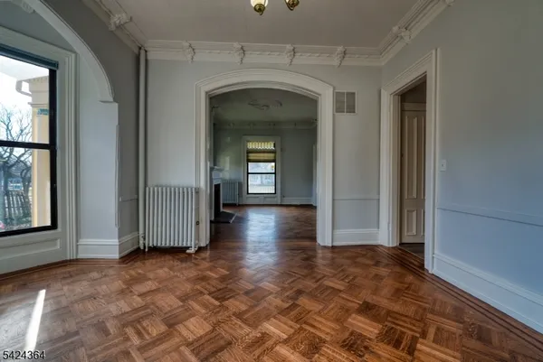 a view of a livingroom with wooden floor and a window