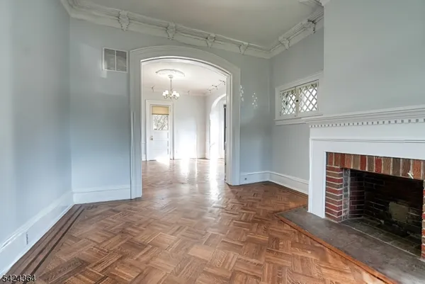 wooden floor with a fireplace in a room