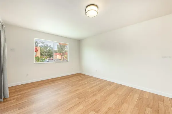 a view of hallway with a large window and wooden floor
