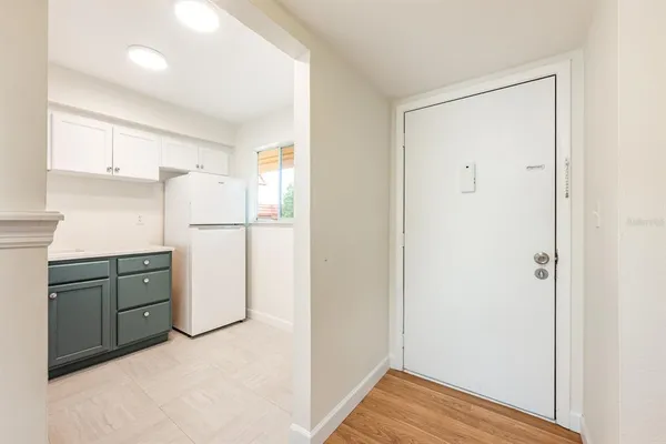 a kitchen with a refrigerator and a sink
