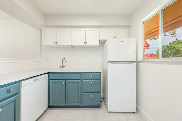 a kitchen with cabinets stainless steel appliances and a counter