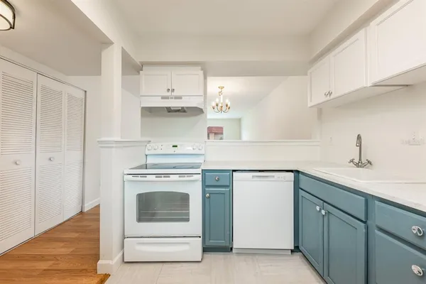 a kitchen with a refrigerator and cabinets
