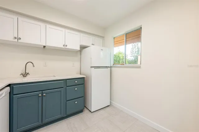 an empty room with wooden floor and window