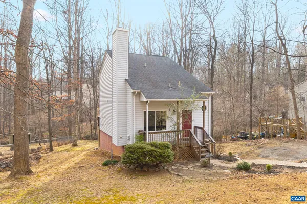 a view of a house with a yard covered in snow