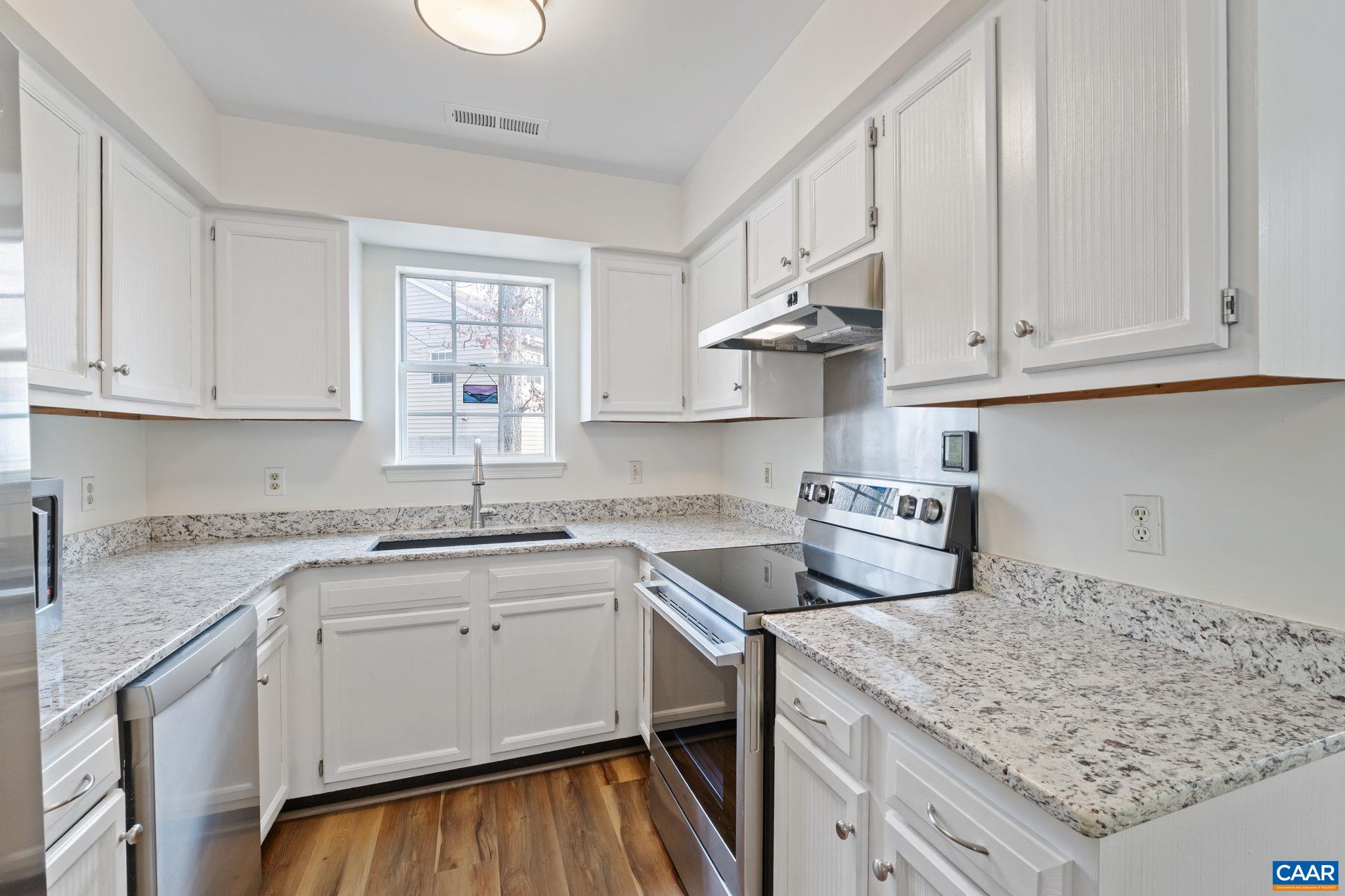 473 Larkspur Road Ruckersville, VA 22968 - Photo 6 of 28 a kitchen with stainless steel appliances granite countertop a sink stove and cabinets