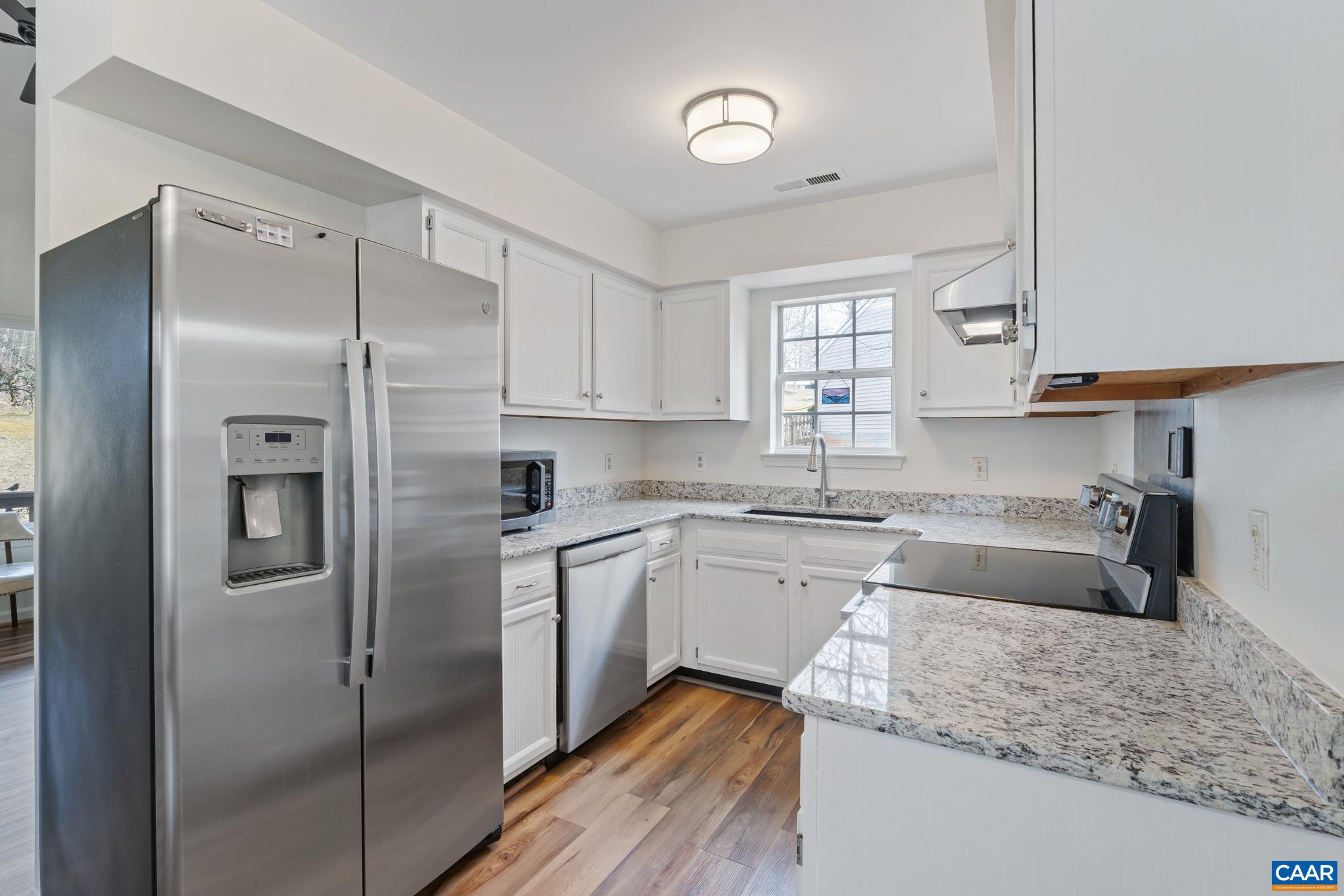 473 Larkspur Road Ruckersville, VA 22968 - Photo 7 of 28 a kitchen with stainless steel appliances granite countertop a sink refrigerator and cabinets