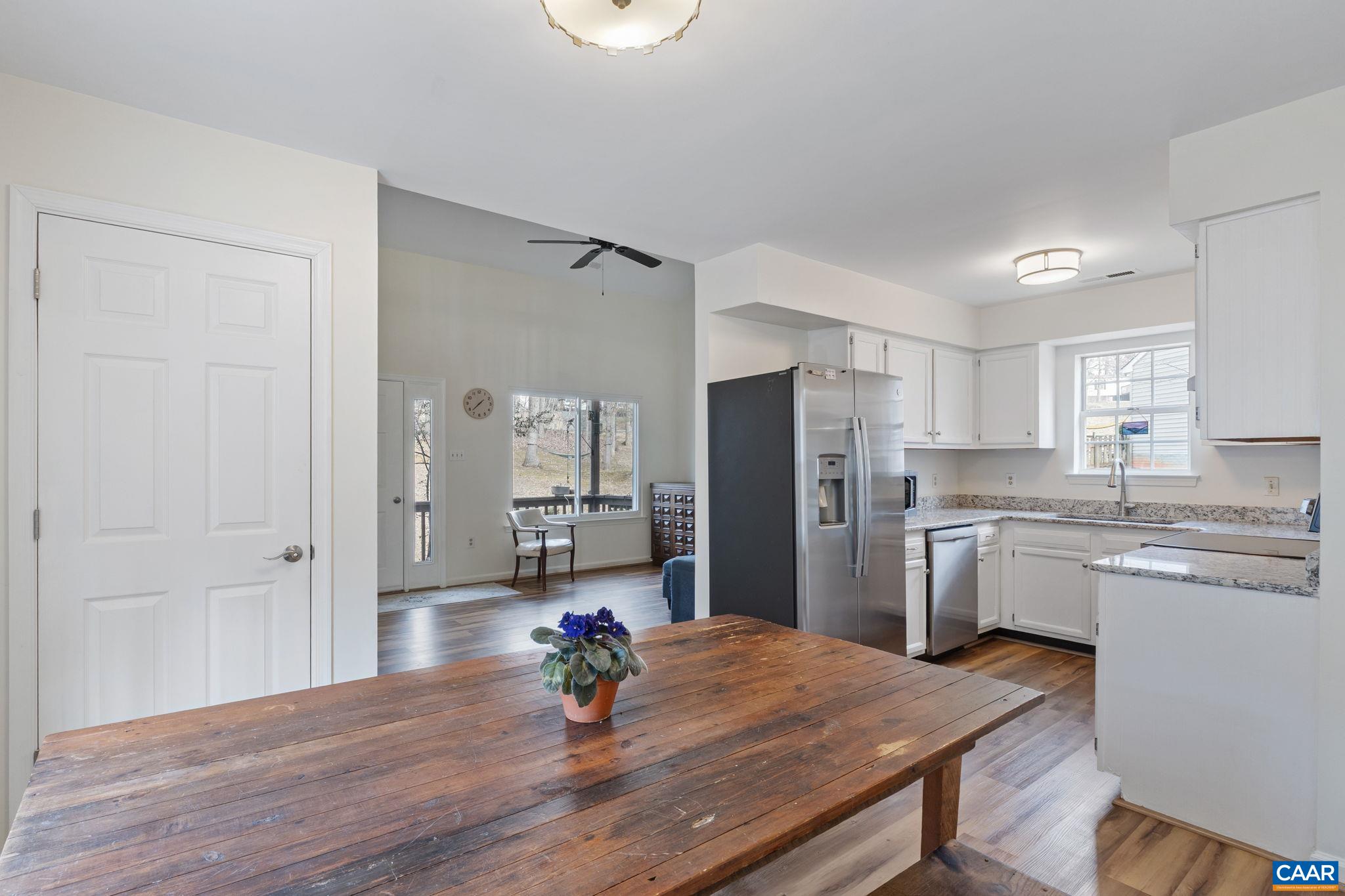 473 Larkspur Road Ruckersville, VA 22968 - Photo 9 of 28 a kitchen with stainless steel appliances granite countertop a sink dishwasher and a refrigerator with wooden floor