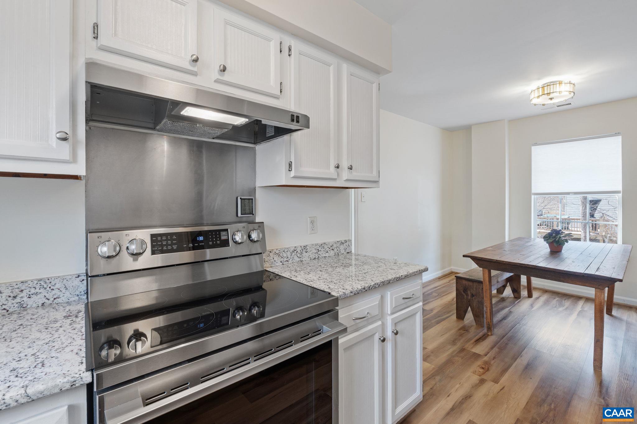 473 Larkspur Road Ruckersville, VA 22968 - Photo 10 of 28 a kitchen with a stove and a microwave