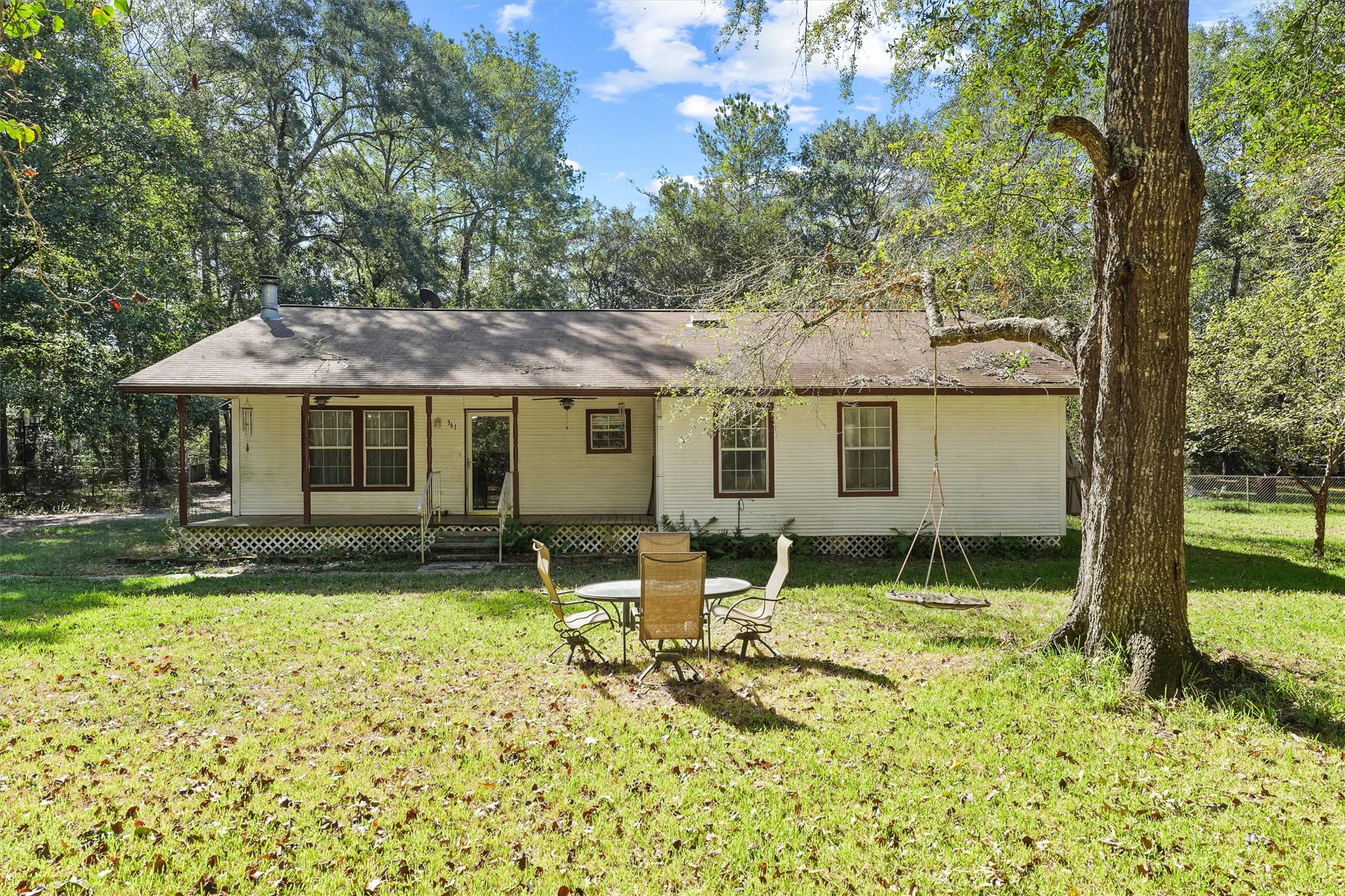 a backyard of a house with yard and outdoor seating