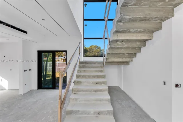 a view of staircase with white walls