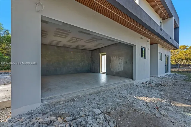 a front view of a house with a tree