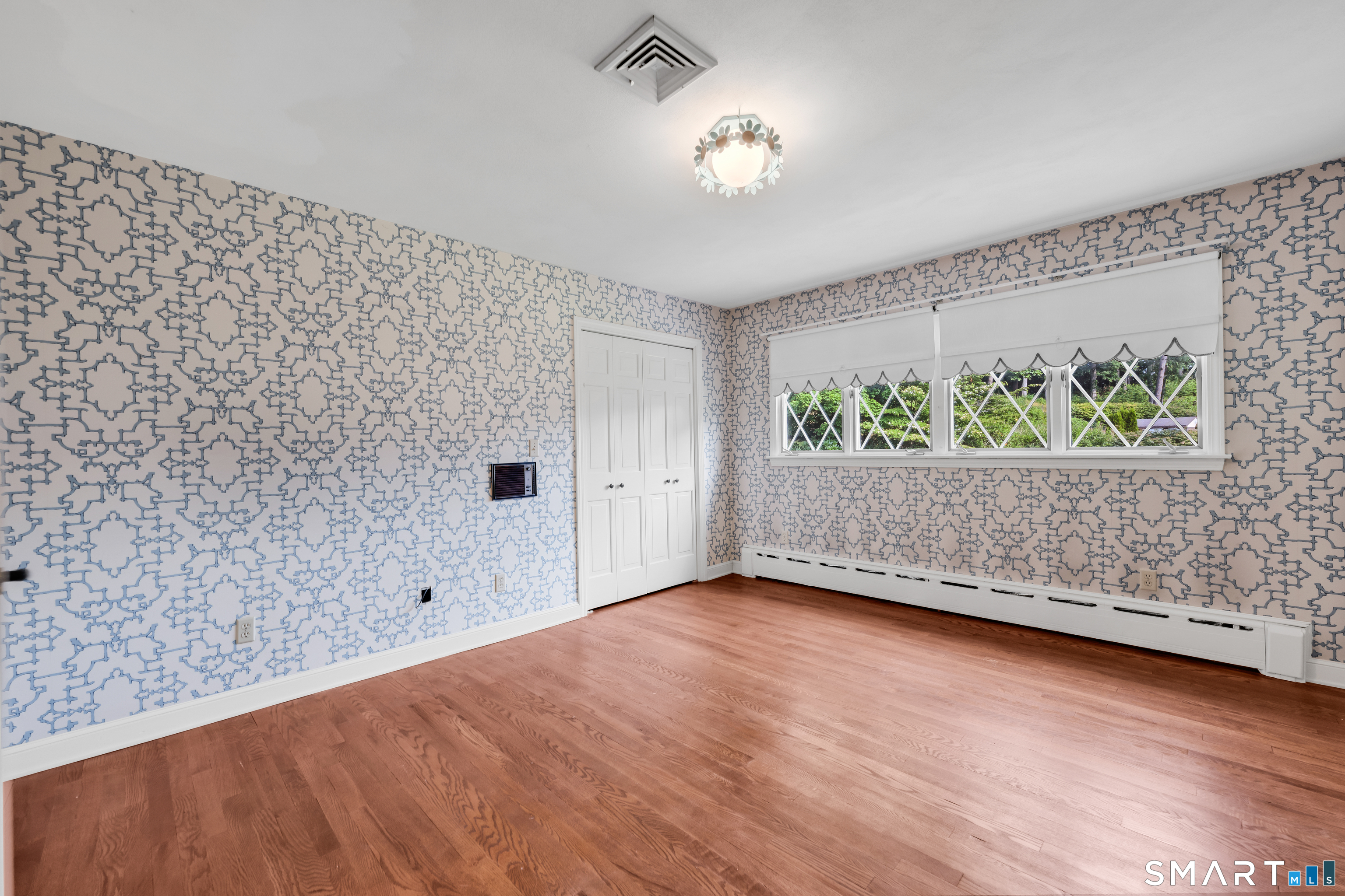 232 Maybrook Road Waterbury, CT 06708 - Photo 26 of 38 an empty room with wooden floor and windows