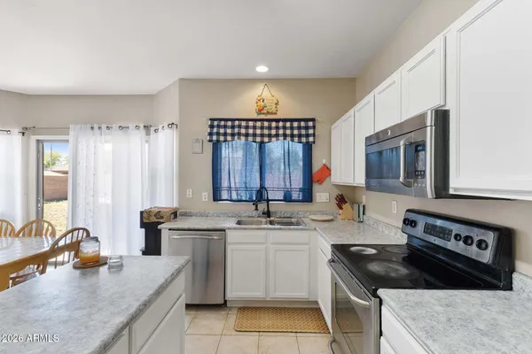 a kitchen with stainless steel appliances a refrigerator sink and stove