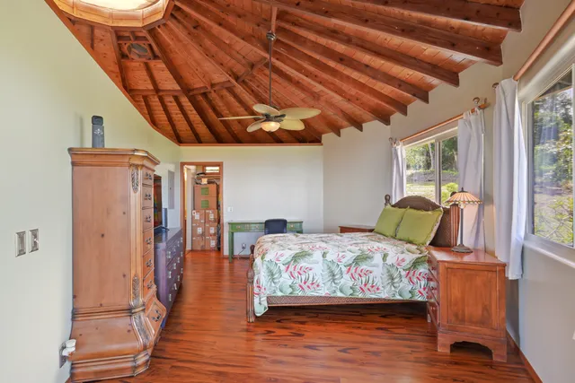 a bedroom with a bed next to a window