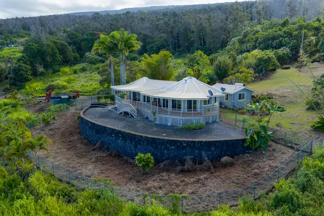 a view of a house with a yard and hanging chair
