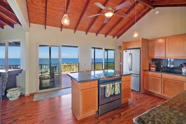 a kitchen with stainless steel appliances granite countertop a stove and a refrigerator