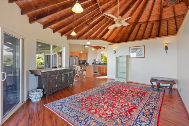 a living room with a couch and wooden floor