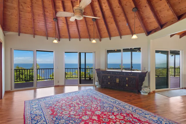 a living room with a couch and dresser with wooden floor