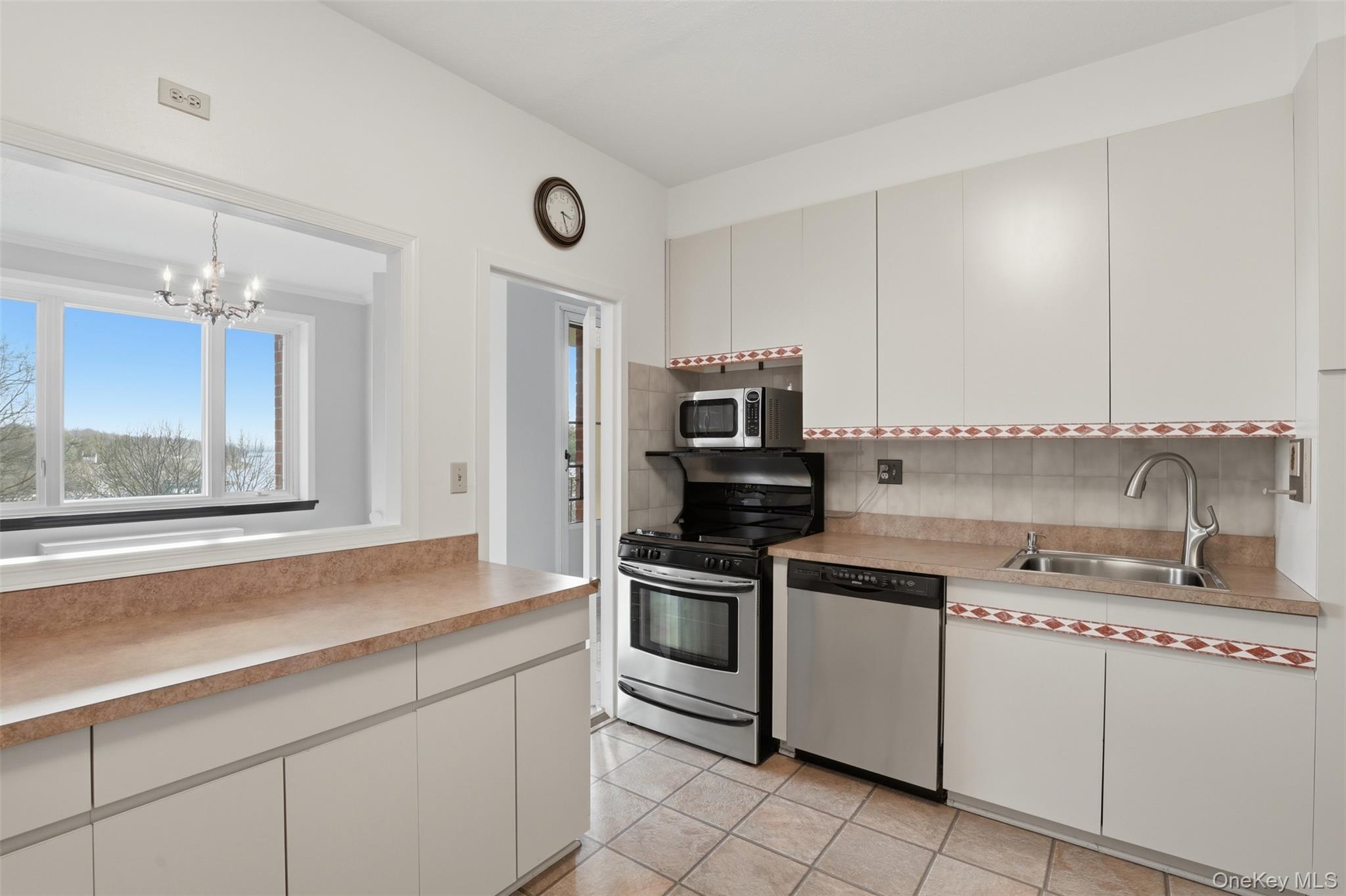 16 Rockledge Avenue, Unit 2C1 Ossining, NY 10562 - Photo 12 of 48 a kitchen with stainless steel appliances a sink stove and refrigerator
