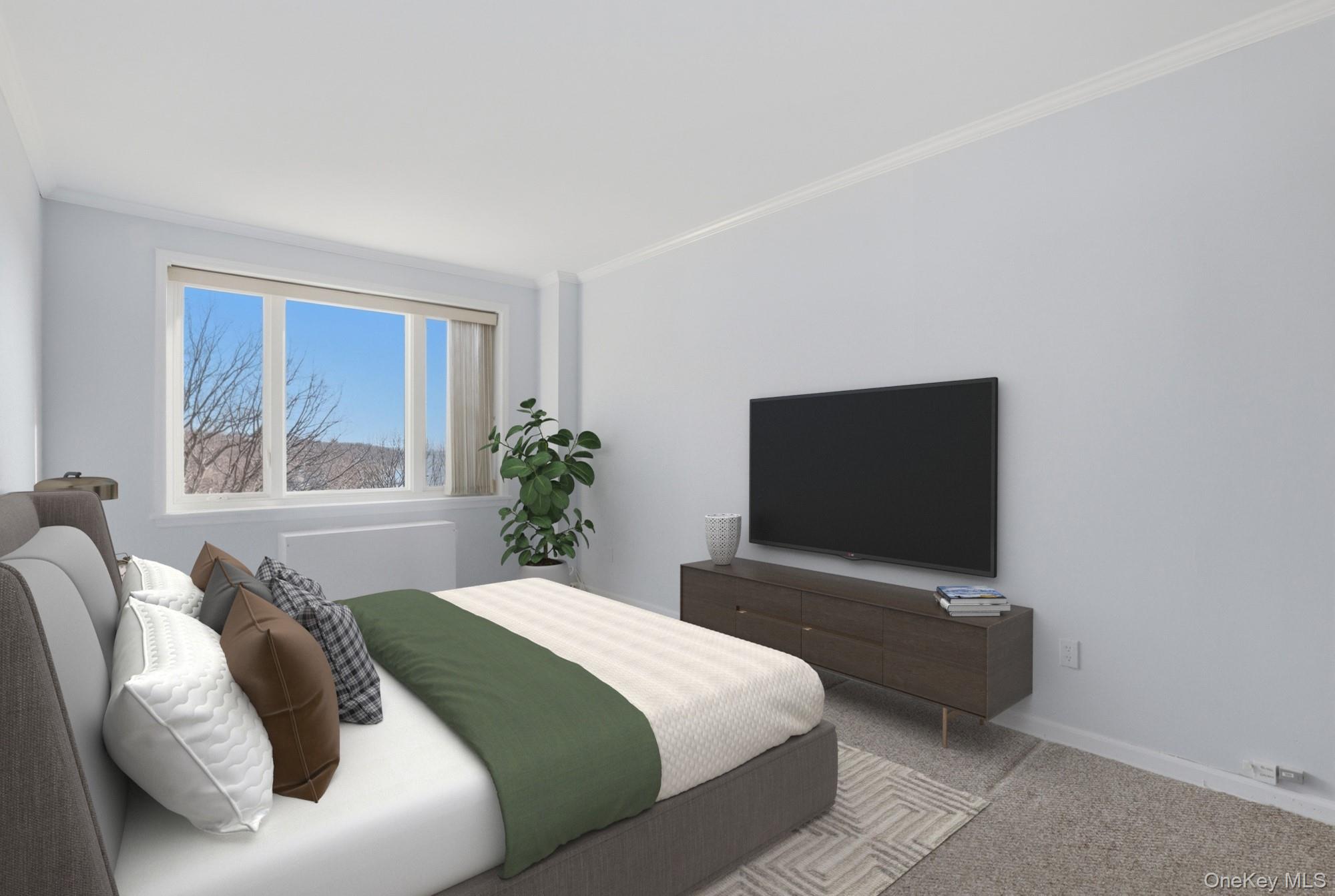 16 Rockledge Avenue, Unit 2C1 Ossining, NY 10562 - Photo 21 of 48 a bedroom with a bed and a flat screen tv