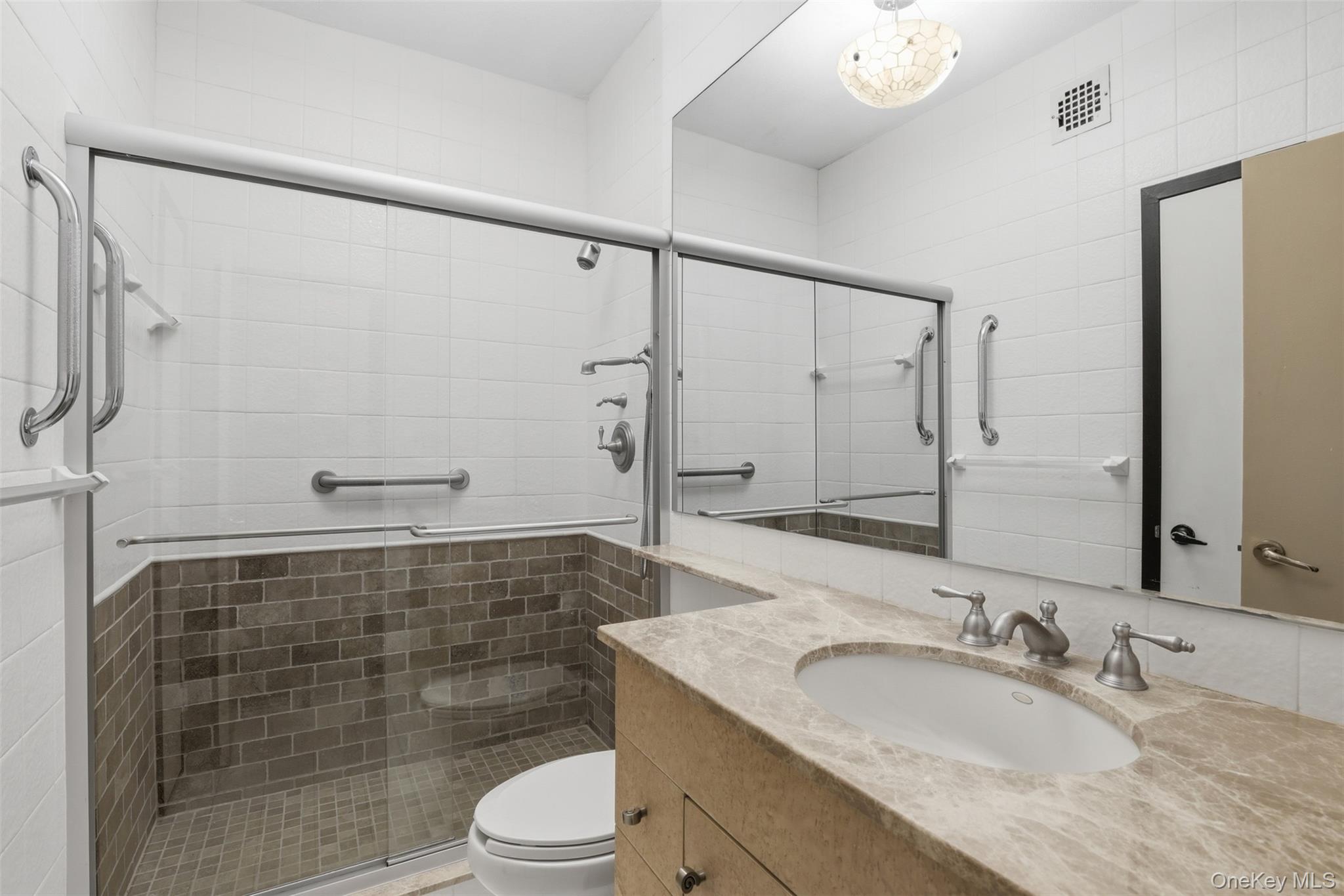 16 Rockledge Avenue, Unit 2C1 Ossining, NY 10562 - Photo 22 of 48 a bathroom with a double vanity sink toilet and shower