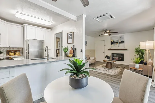 a dining room with furniture potted plants and a chandelier